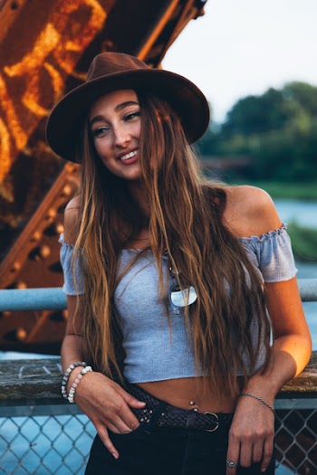  A young caucasian woman smiling at sunset 