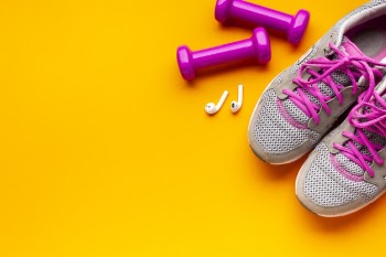 Above view sporty items on yellow background Free Photo