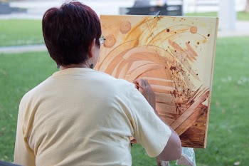 Abstract painting by woman outdoors