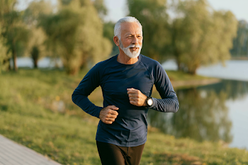 Active Older Man Jogging by a Lakeside Path
