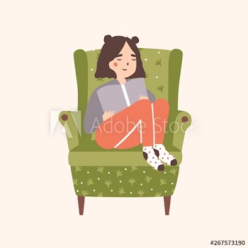 Adorable girl sitting in comfy armchair and reading book isolated on light background