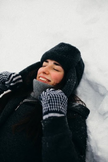 Adult woman laying down on snow · Free Stock Photo