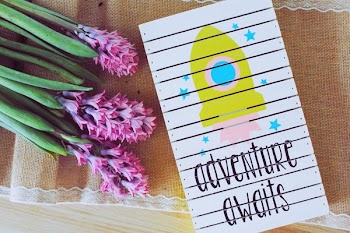 Adventure Awaits Art Work Beside Purple Flowers