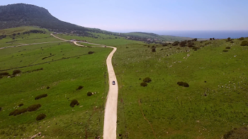 Aerial Of The Hilly Road With Driving Lonely Car Stock Video ...