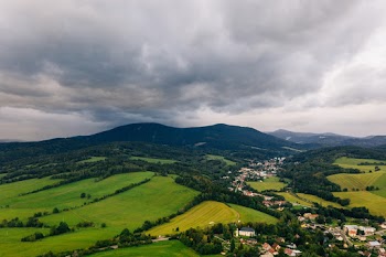 Aerial Photo of A Town And Its Surrounding Landscape Under Cloudy Sky