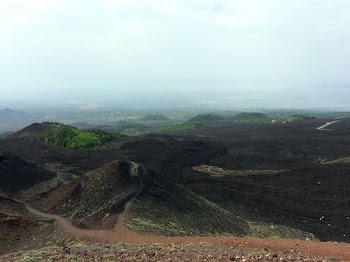 aerial photo of brown hills under cloudy sky during daytime