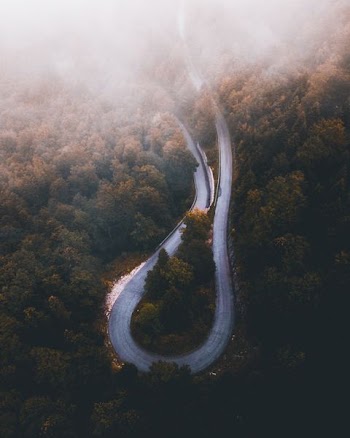 aerial photo of curved highway during daytime