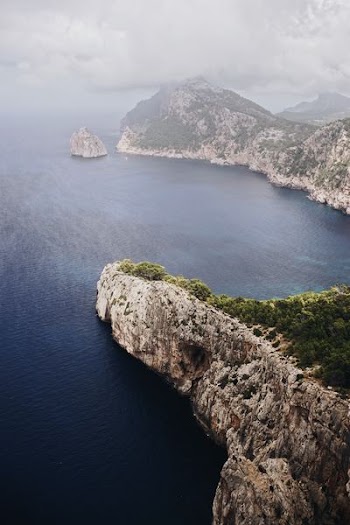 aerial photo of gray rocky islands beside body of water during daytime
