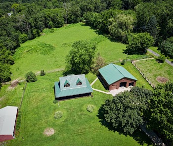 Aerial Photo of House Surrounded by Luscious Land