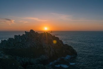 aerial photo of island on sea during sunrise