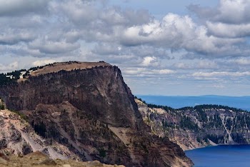 aerial photo of mountain near body of water