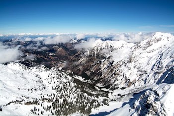 aerial photo of mountains covered with snow under cloudy sky