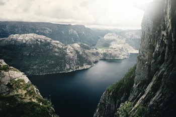 Aerial Photo Of Mountains Near Body Of Water 