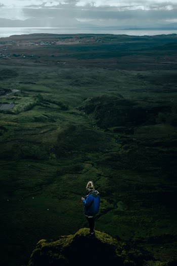 Aerial Photo of Person Standing on Edge of a Cliff