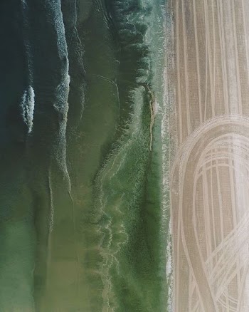 aerial photo of soil and body of water