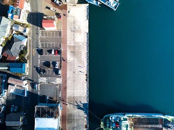 aerial photo of white boat near houses during daytime