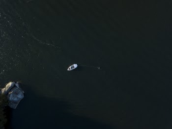 Aerial Photograph of a Boat on Body of Water