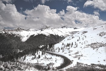 Aerial Photograph Of A Road Surrounded By Snow Covered Mountains