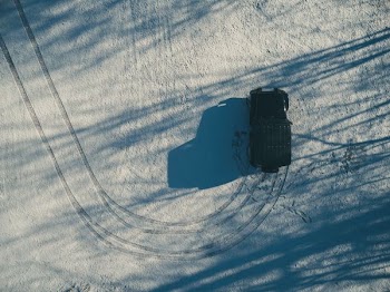 aerial photography of black SUV on dirt road at daytime