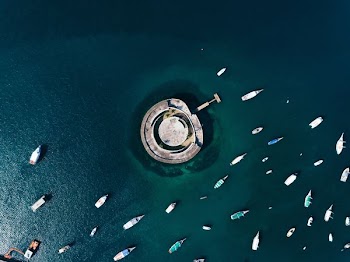 aerial photography of boats and building on body of water during day