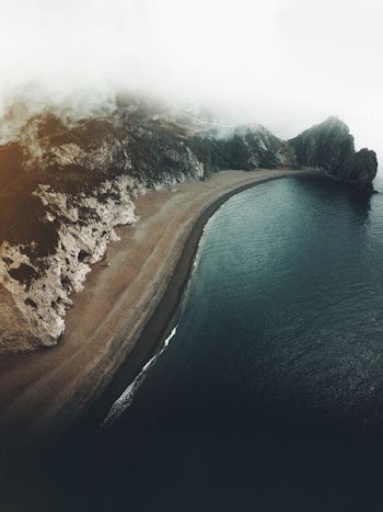 aerial photography of body of water and seashore