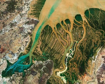 aerial photography of body of water surrounded by rock formation