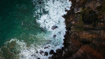aerial photography of brown cliff near body of water