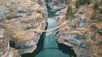 Aerial Photography of Brown Hanging Bridge Connecting Two Cliffs