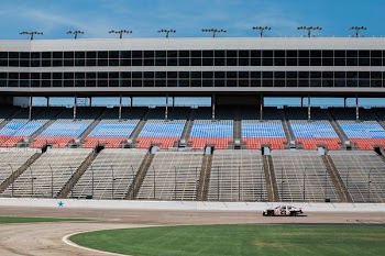 aerial photography of car on stadium under clear blue sky