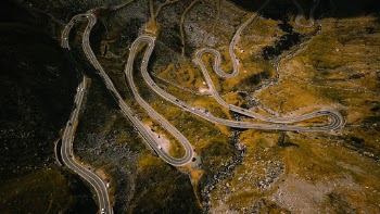 Aerial photography of curvy roads and hairpins in Romanian mountains, Transfagarasan.