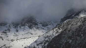 aerial photography of fog covering mountain top