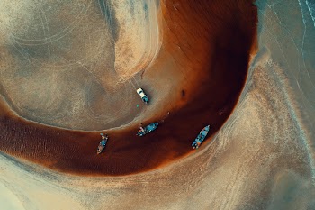 Aerial Photography of Four Blue Boats on Body of Water