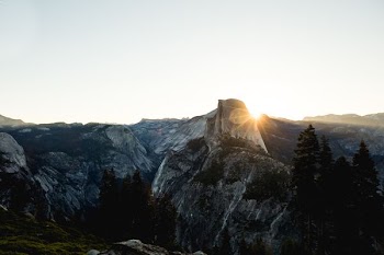 aerial photography of gray and black rocky mountains with sun rays at daytime