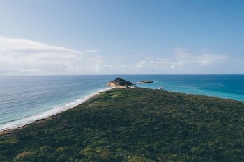 aerial photography of green island surrounded by water