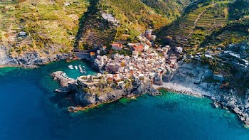 aerial photography of houses on hilltops near the ocean
