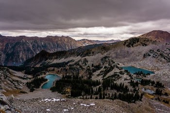 aerial photography of lake surround by mountains
