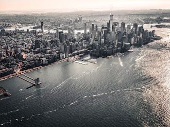 aerial photography of large body of water across city with high-rise buildings at daytime