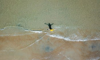 Aerial Photography of Man on Shallow Water