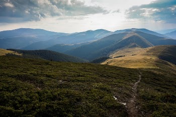Aerial Photography of Mountain Under Cloudy Sky