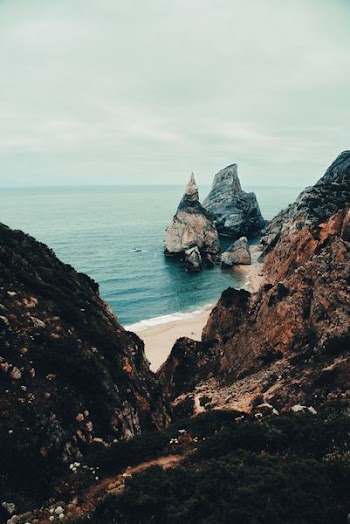 aerial photography of mountains and sea at the distance