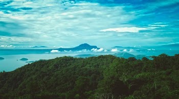 aerial photography of mountains near body of water