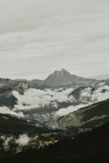 aerial photography of mountains surrounded by clouds