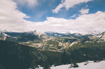 aerial photography of mountains under white cloudy skies
