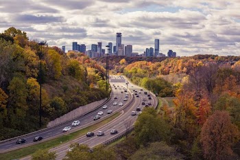aerial photography of passing vehicles on highway leading to city