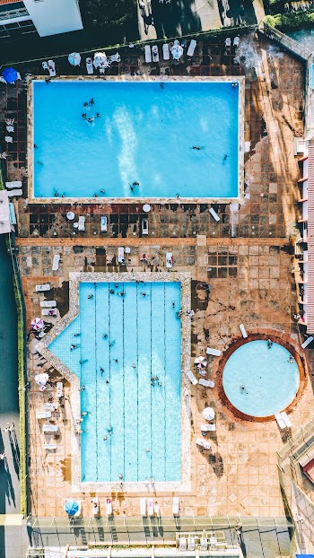 Aerial Photography of People on Rectangular and Circular Swimming Pool
