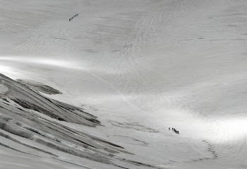 aerial photography of people walking on mountain field with snow
