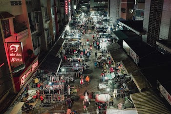 Aerial Photography of People Walking on Street Near Buildings during Night Time