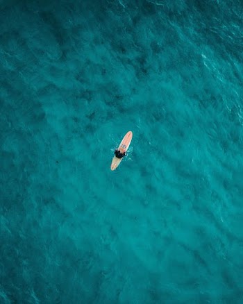 aerial photography of person on surfboard on sea