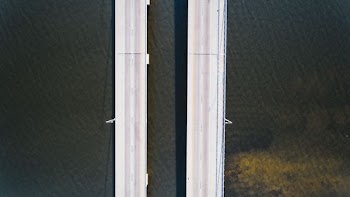 aerial photography of road near body of water