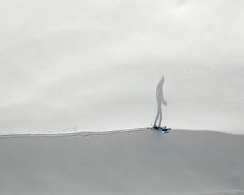 Aerial Photography of Skiing Person With Shadow on Snow